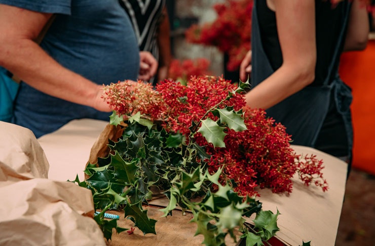 Christmas bush and holly wrapped in brown paper.